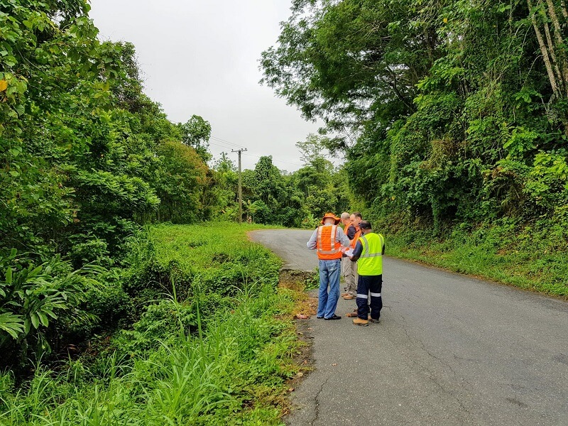 People in high-vis vests on a road in PNG
