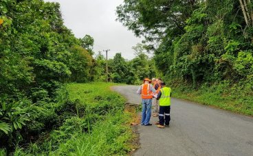 People in high-vis vests on a road in PNG