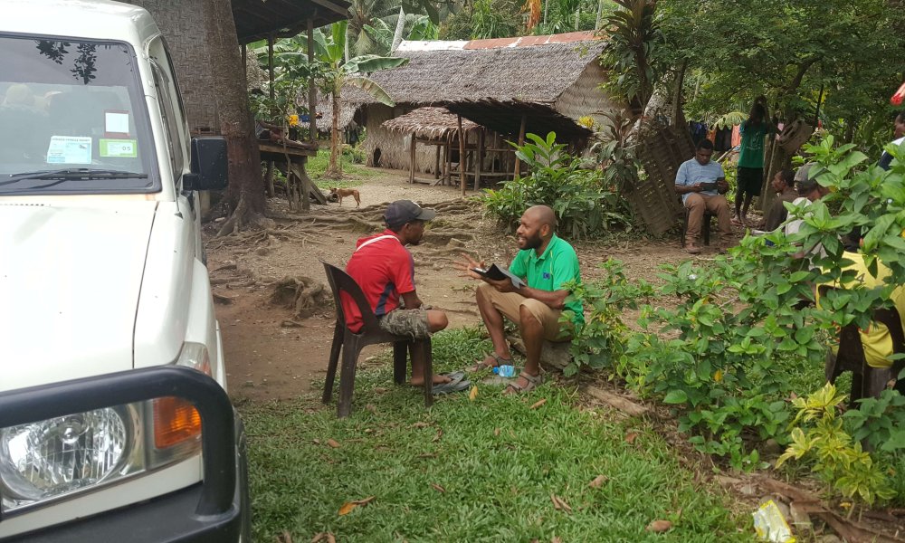 Two men sitting down talking
