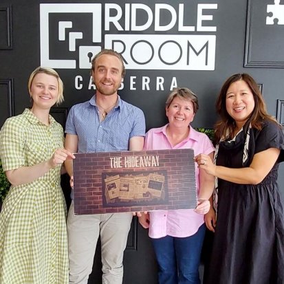 Nina, Rob, Nicky, and Min celebrate their win in our end of year Riddle Room team activity